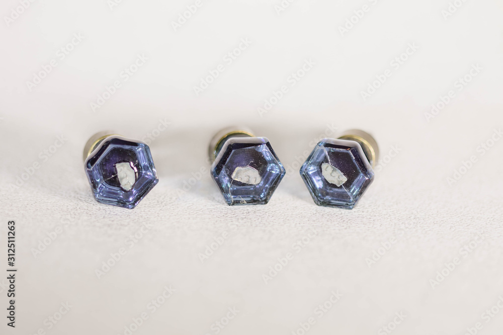 front of three very small blue glass drawer knobs or pulls front of three very small blue glass drawer knobs or pulls