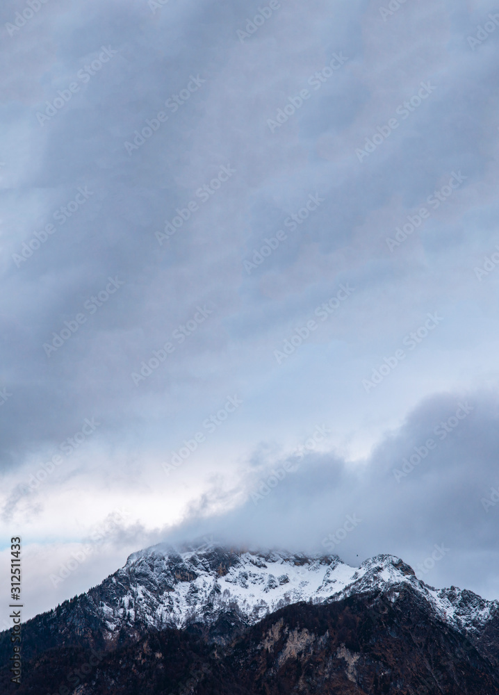mountain peak with snow in foggy cloudy weather time highland winter wallpaper pattern landscape vertical picture and empty copy space for your text here