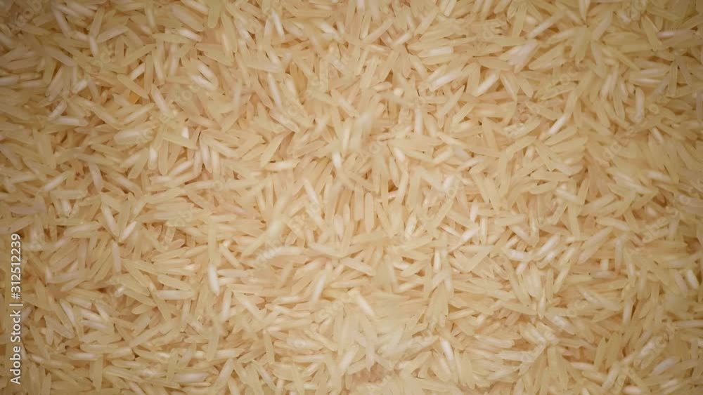 White raw organic basmati rice rotation background. Food ingredient background. Top view, healthy lifestyle concept. White raw organic basmati rice rotation background. Food ingredient background. Top view, healthy lifestyle concept.