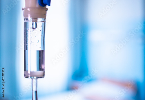 Obraz na płótnie Dripping medical perfusion close up equipment in clinic background. Saline Solution IV Drip Fluid for Infusion in Hospital. Intravenous infusion tube equipment in hospital. Health patient concept. w salonie