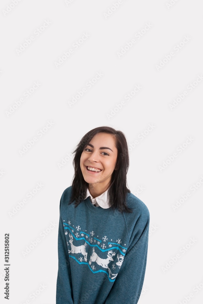 Portrait of happy woman in Christmas jumper against gray background Portrait of happy woman in Christmas jumper against gray background