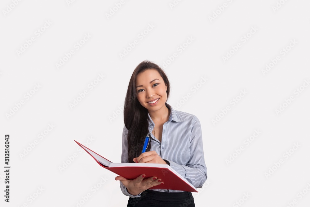 Portrait of happy businesswoman with book and pen over white background Portrait of happy businesswoman with book and pen over white background