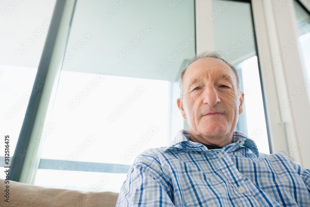 Portrait of senior man relaxing in living room Portrait of senior man relaxing in living room