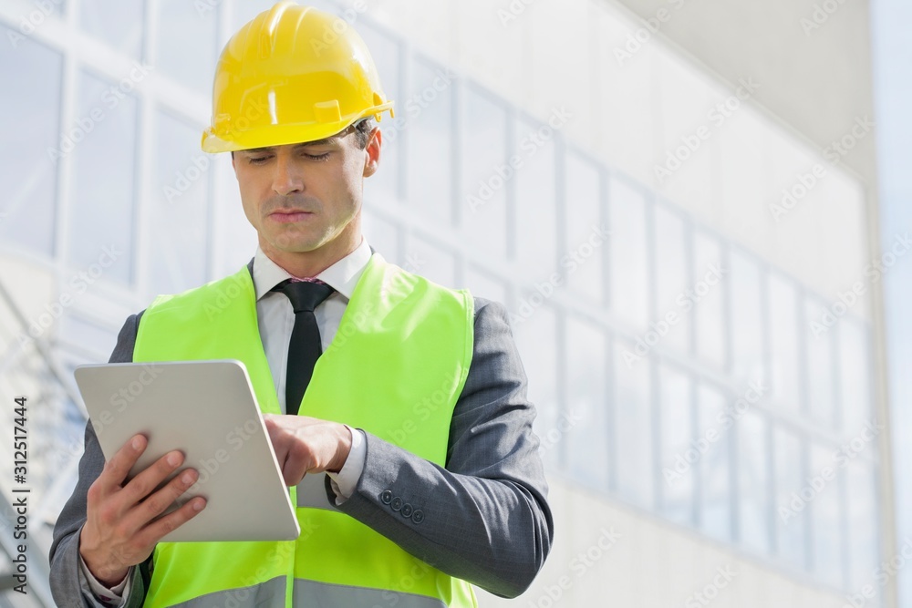 Young male engineer using digital tablet outside industry Young male engineer using digital tablet outside industry