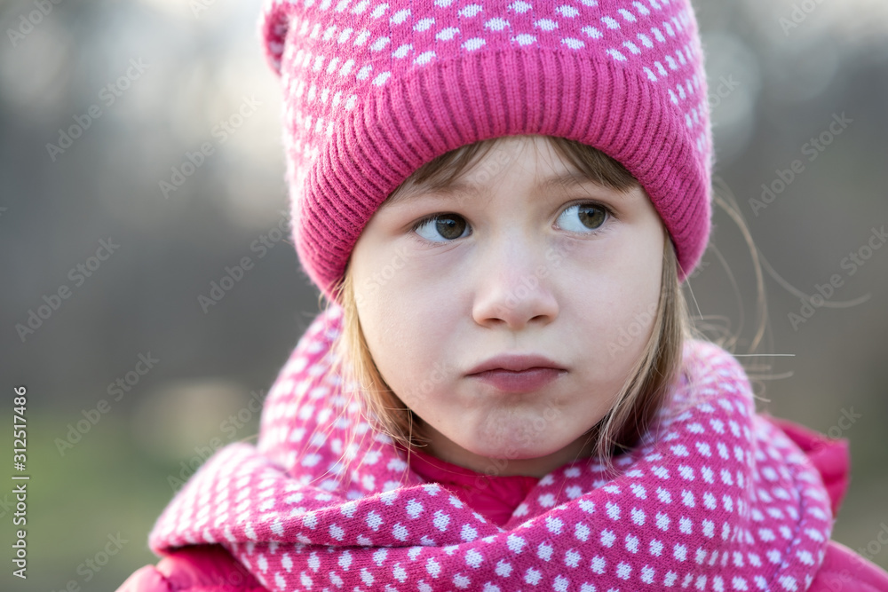 Pretty child girl in warm knitted winter clothes outdoors. Pretty child girl in warm knitted winter clothes outdoors.