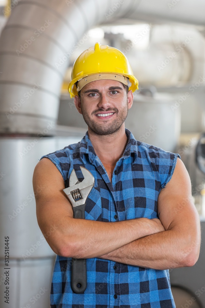 Portrait of confident industrial worker standing arms crossed