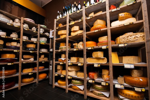 Cheese arranged in shelves at store