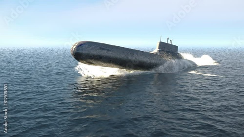 A nuclear-powered military submarine emerges from the depths of the ocean. photo