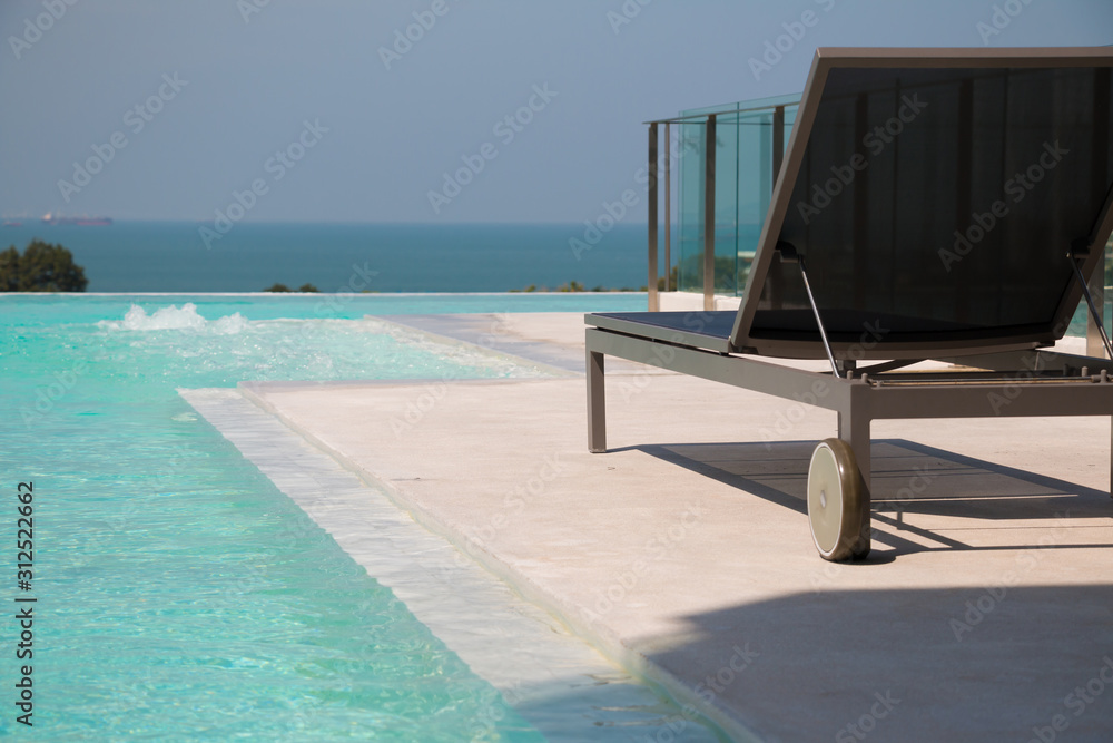Fototapeta premium sunbed with infinity pool