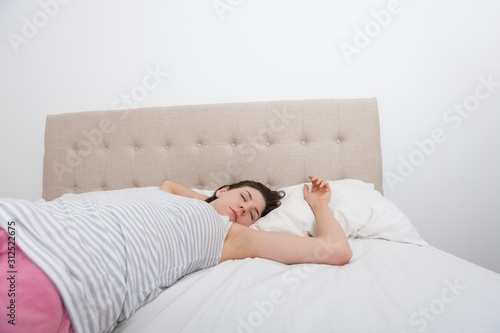 Young woman sleeping comfortably in bed
