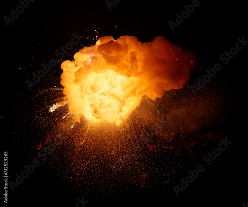 Fiery bomb explosion with sparks isolated on black background. Fiery detonation.
