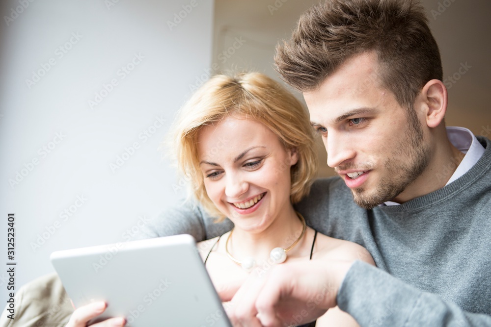 Happy young couple using digital tablet in cafe Happy young couple using digital tablet in cafe