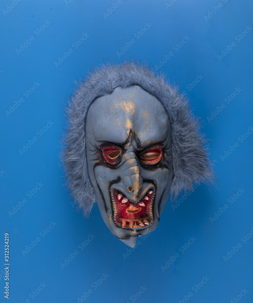 scary blue mask isolated on blue background