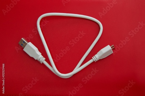 USB cable on red background. Connect