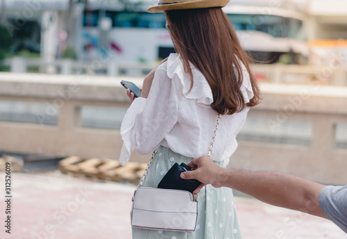 Konstfotografi Stealing wallet from the pickpocket from shoulder bag of tourist girl