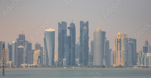 Doha  Qatar - probably the most notable landmark in Doha  the Corniche is a waterfront promenade extending for seven kilometers along Doha Bay. Here in particular its skyline