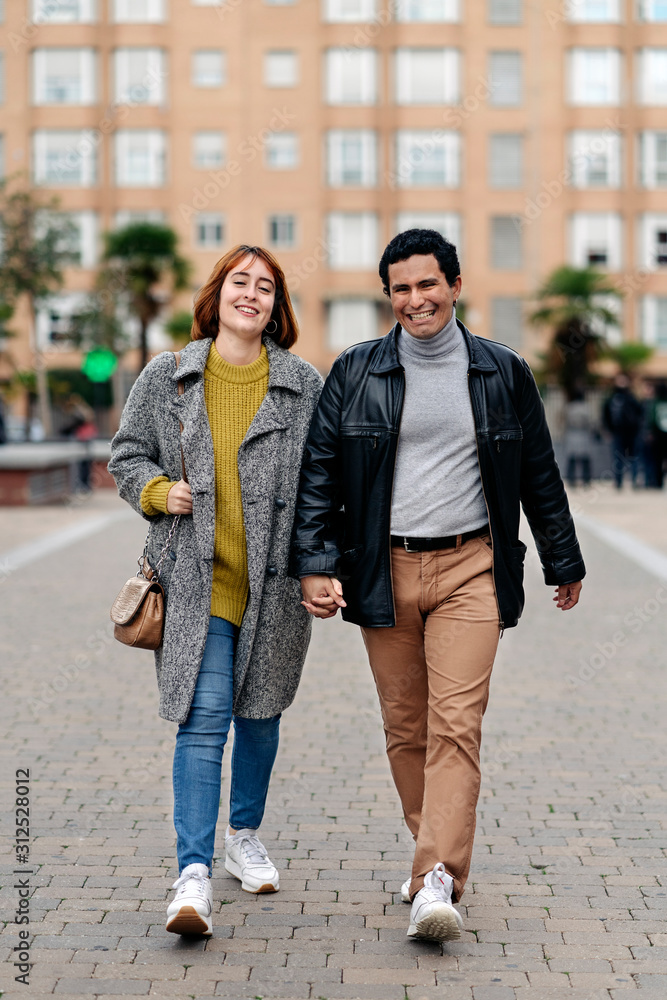 Happy couple walking together in the city
