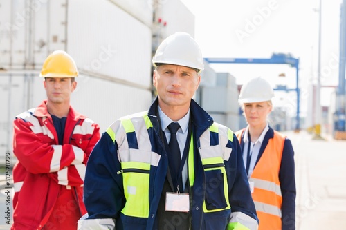 Confident workers standing in shipping yard