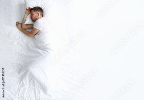 Young caucasian beauty woman sleeping on white bed photo
