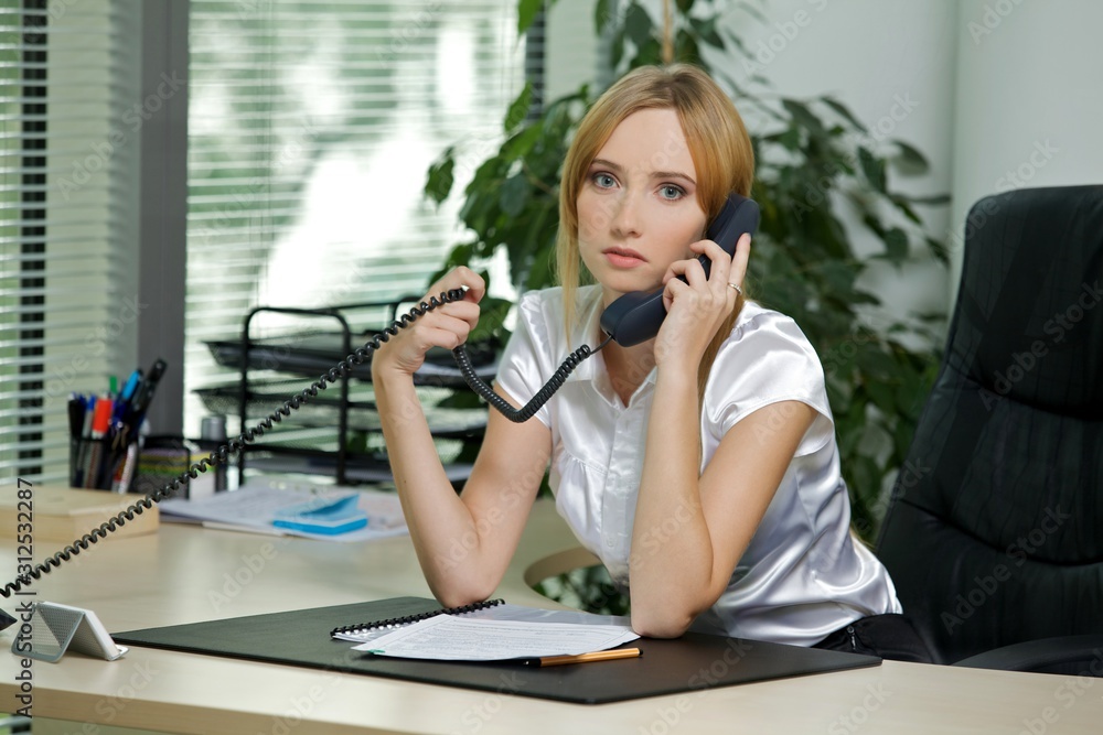 Portrait of businesswoman using phone at office Portrait of businesswoman using phone at office