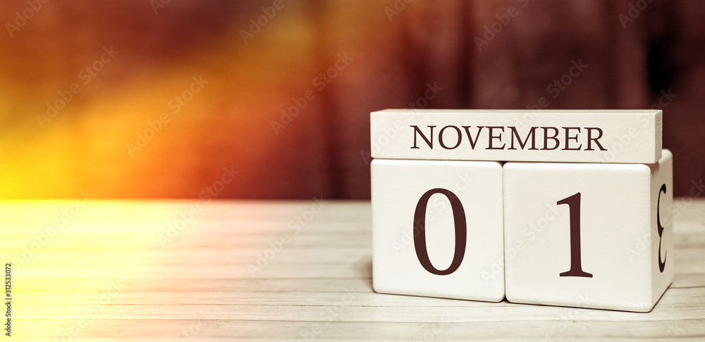Calendar reminder event concept. Wooden cubes with numbers and month on November 1 with sunlight. Calendar reminder event concept. Wooden cubes with numbers and month on November 1 with sunlight.