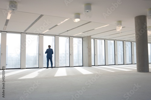 Rear view of mature businessman visiting empty office space © moodboard