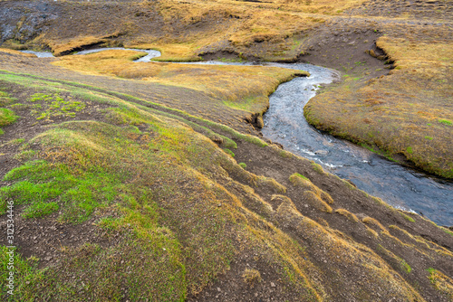 Ketubjorg bird cliffs in the Skagi peninsula. Creek used as leading lines. Shapes  texture and pattern in the Icelandic nature concept.