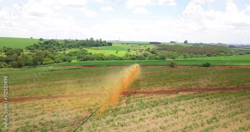 Jets of vinhoto being thrown into the sugar cane plantation to fertilize the plant contain many nutrients to give strength and endurance to grow strong and healthy. Rotate camera. photo