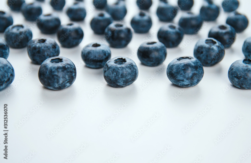 Ripe blueberries on a white background copy space. Large blue berries. Summer harvest of berries. Blueberry treat. Ripe blueberries on a white background copy space. Large blue berries. Summer harvest of berries. Blueberry treat.