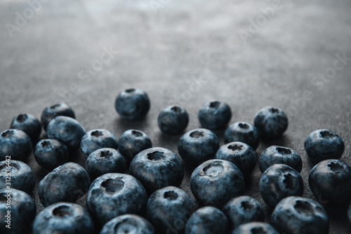  Ripe blueberries on a dark gray rough background copy space. Harvest blueberries. Blue berry background.