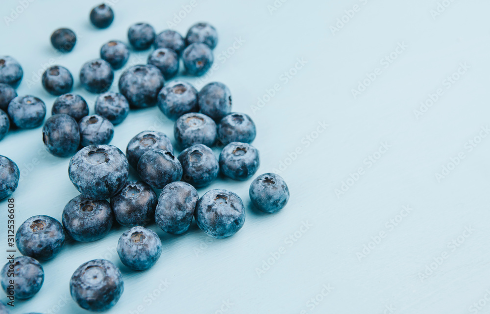 Ripe blueberries on a blue wooden background copy space. Harvest blueberries. Blue berry background. Ripe blueberries on a blue wooden background copy space. Harvest blueberries. Blue berry background.