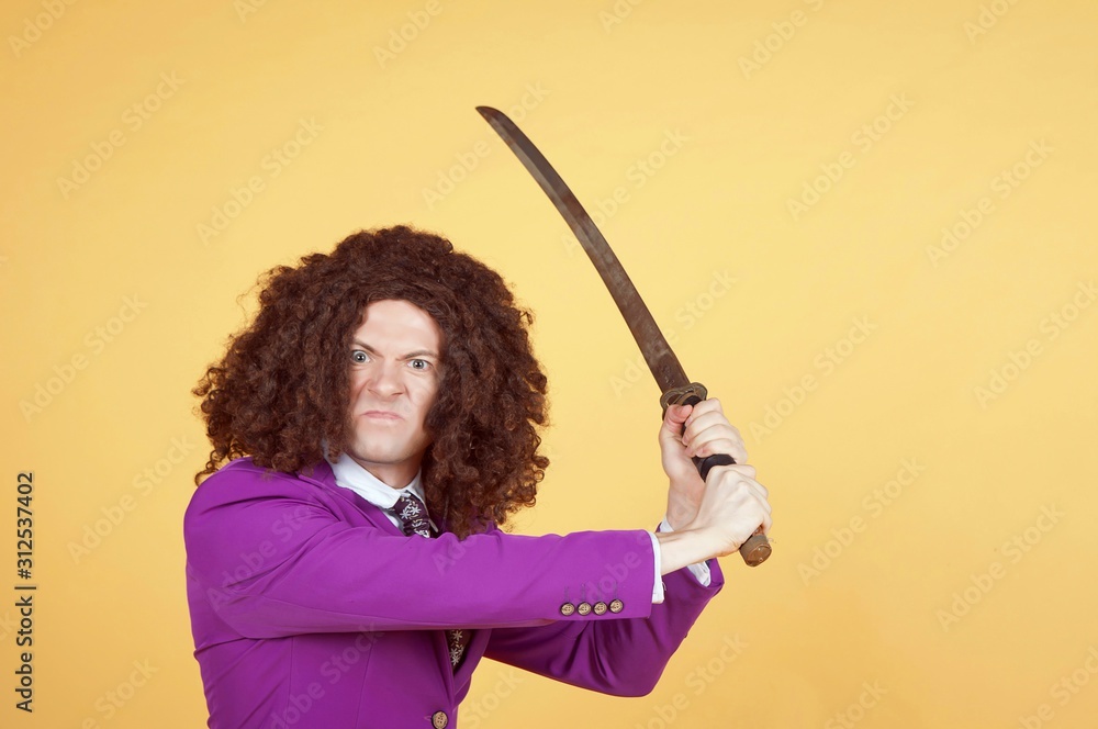 Portrait of a weird angry man wearing wig while holding samurai Portrait of a weird angry man wearing wig while holding samurai