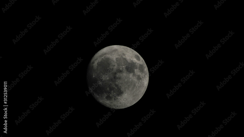 The moon late at night surrounded by total darkness The moon late at night surrounded by total darkness