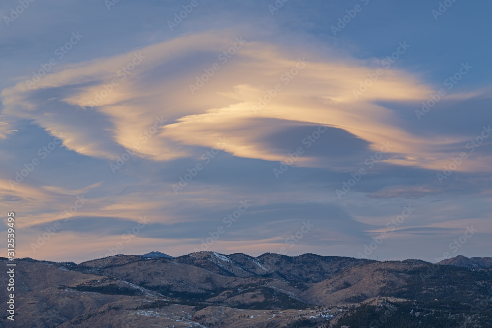 Winter landscape at sunset of lenticular clouds and of the Front Range of the Rocky Mountains from Lost Gulch Overlook, Flagstaff Mountain, Boulder, Colorado, USA