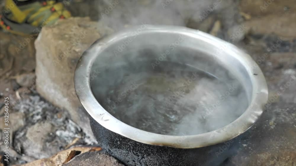 Boiling water over a fire place in the nature. Boiling water over a fire place in the nature.
