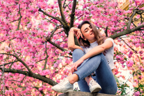 Girl enjoying vacation to japan on sakura blossoming