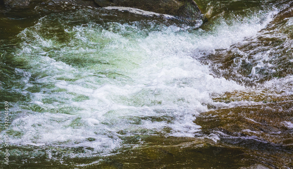 Rocky shore of a mountain river with foaming water_ Rocky shore of a mountain river with foaming water_