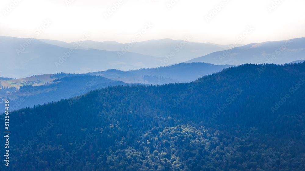 Strands of mountain ranges. The mountains are shrouded in blue mist_