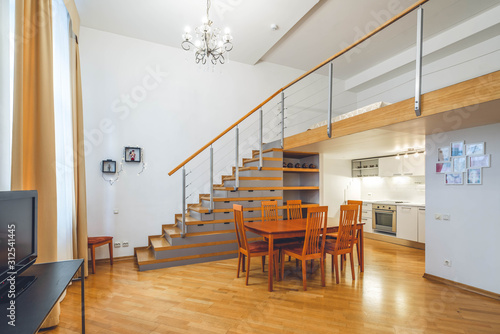 Interior in warm tones. Private house. Staircase to the second floor. Kitchen set. photo