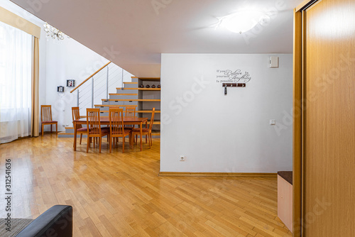 Modern light interior. Wooden furniture and shelves. Staircase. Studio apartment.