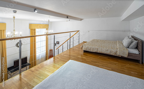 Bedroom on the second floor in apartment. Modern light interior.