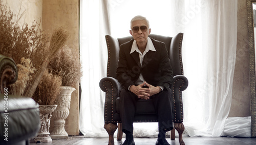 Senior Asian man handsome and suit sitting in rich expensive house