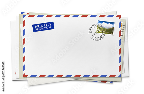 Stack of white paper envelopes for letters - front side with stamp.
