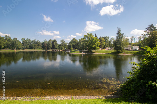 A pond surrounded by forest in the back of Ostankino Park