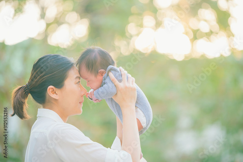 Mother And Baby outdoors. Nature.Portrait of happy loving mother and her baby outdoors,