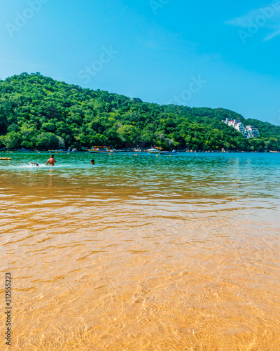 People swimming in Majahua's beach in Acapulco