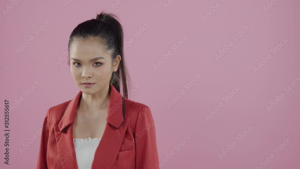 Young, Asian woman with strong, angry expression, long hair pulled back in a ponytail Young, Asian woman with strong, angry expression, long hair pulled back in a ponytail