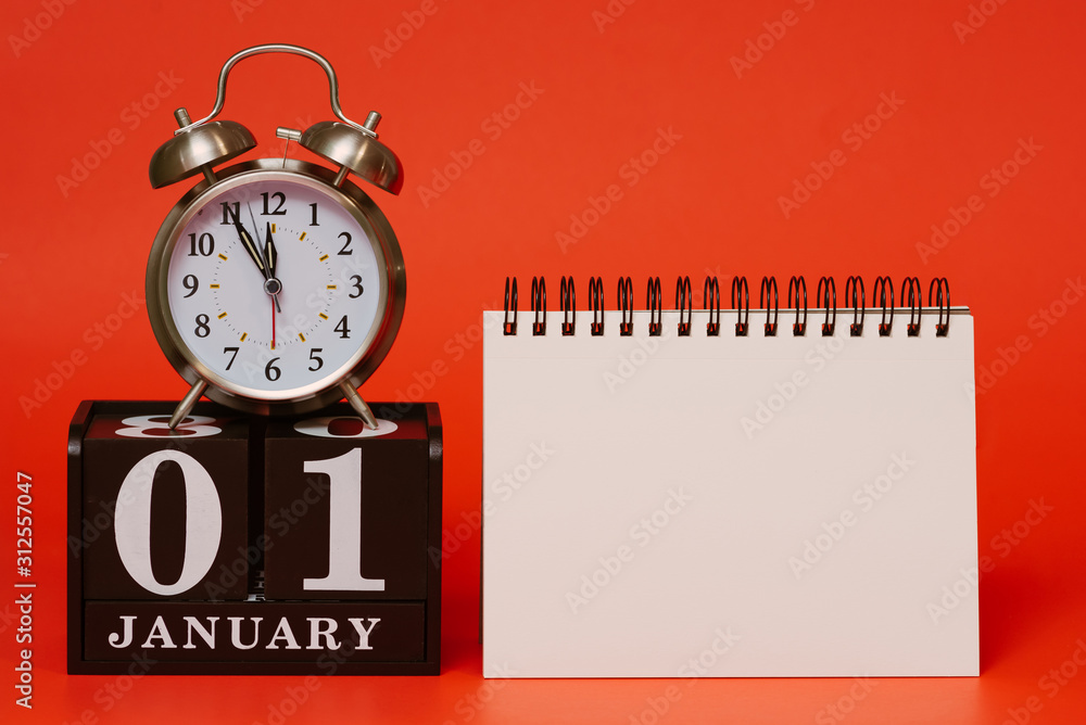new year 2020 concept, alarm clock placed on top of wooden blocks with the calendar date of january 1st