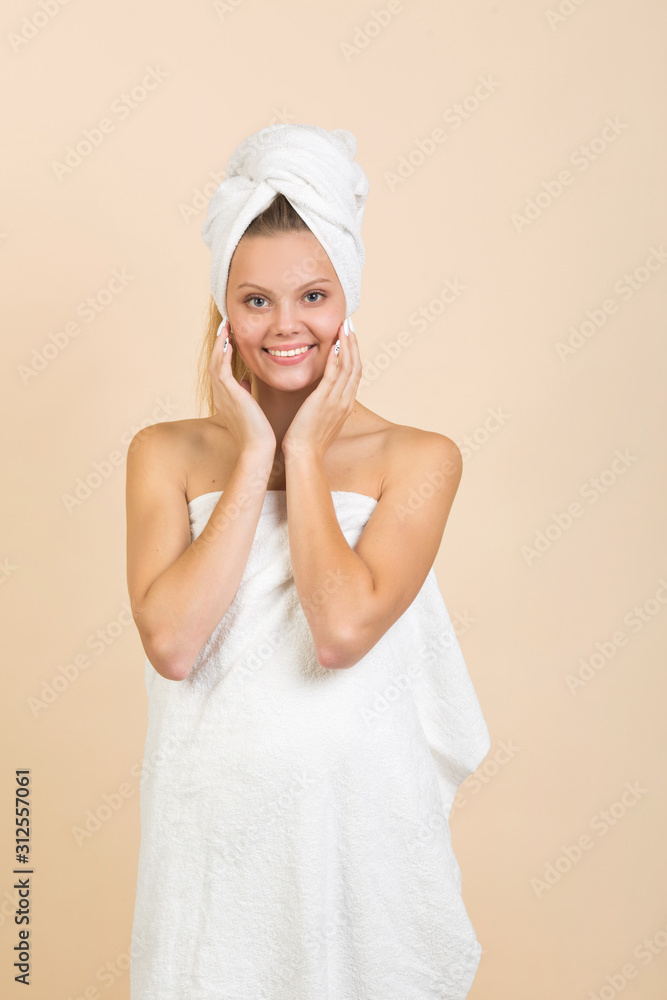 beautiful young woman on a beige background in a white towel beautiful young woman on a beige background in a white towel
