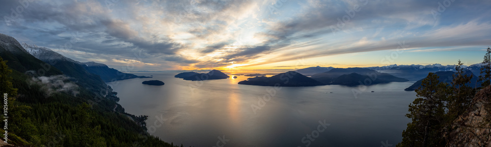 Tunnel Bluffs Hike, in Howe Sound, North of Vancouver, British Columbia, Canada. Panoramic Canadian Mountain Landscape View from the Peak during sunny winter sunset.